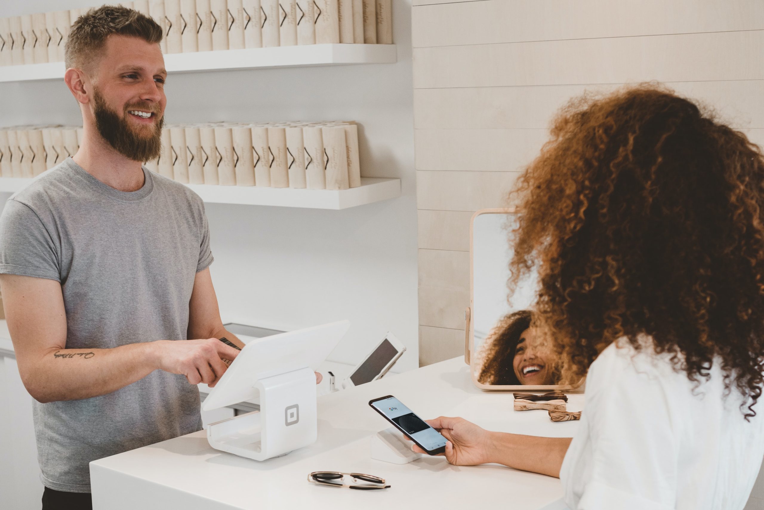 Customer smiles at sales clerk.